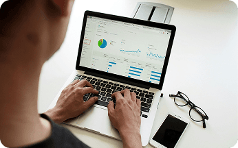 Person analyzing a dashboard on a laptop